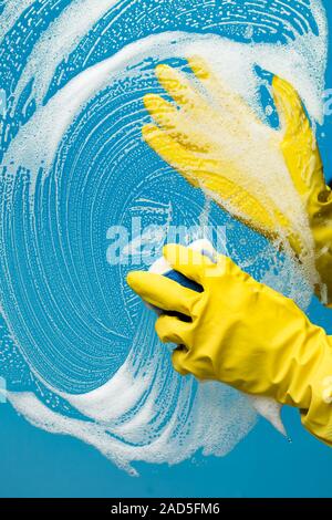 Man washes glass with foam Stock Photo