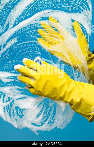 Person washes window with foam Stock Photo