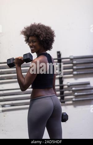 black woman doing bicep curls Stock Photo