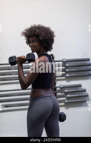 black woman doing bicep curls Stock Photo