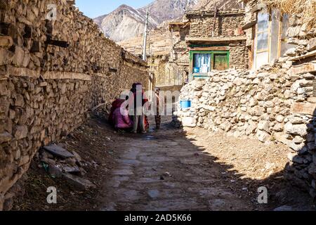 Manang, Nepal - November 11, 2015: Group of little Nepali children playing in the street in mountain village Stock Photo