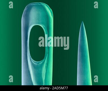 Coloured scanning electron micrograph (SEM) of Eye and tip of a sewing needle. A sewing needle is used in sewing to pull thread through fabric. It has Stock Photo