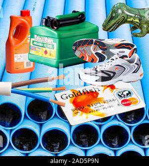 Common items made from PVC. Polyvinyl chloride or PVC has a variety of uses. On a background of double-walled corrugated cabling pipes - (CW) an infla Stock Photo