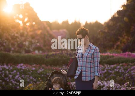 mother and daughter in flower garden Stock Photo