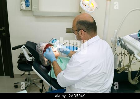 Dentist with patient. Dentist working on a patient. Stock Photo