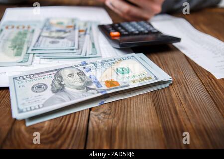 Blue leather wallet with money on wooden table Stock Photo