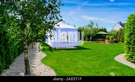Party tent - garden party or wedding entertainment tent in modern garden Stock Photo