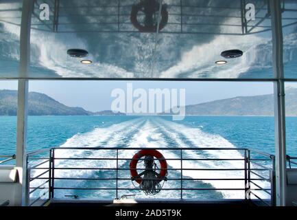 Wake caused by speed boat, reflections and closeup trail on water surface Stock Photo