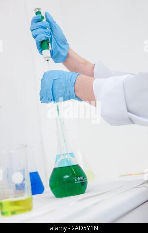 Water purification research. Laboratory research microbiologists testing water purification reactions. They are testing the effects of chlorine dioxid Stock Photo