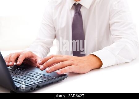 Businessman working on laptop over white Stock Photo