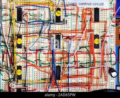 Logic control circuit. Circuit board wired with logic gates and other electronic components. Chips containing NOT, NOR, AND and OR logic gates are lab Stock Photo