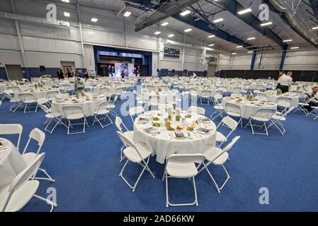 Large dual-purpose  Banquet hall facility being set up for a banquet. Stock Photo