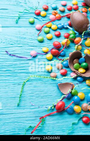 Multicolored dragees, chocolate eggs, ribbons Stock Photo