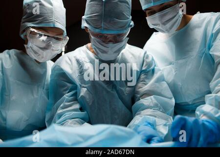 Doctors working in operating room Stock Photo