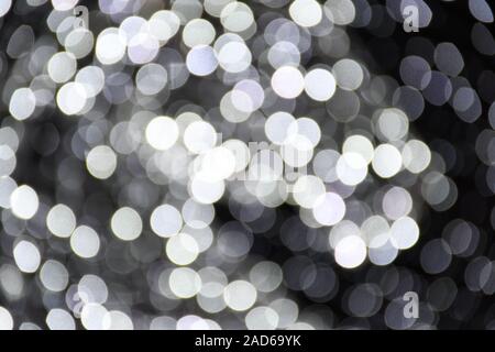 Abstract background white and grey bokeh lights, frozen, winter, cascade of sparks, cold feeling, coldness, silver, sparkling Stock Photo