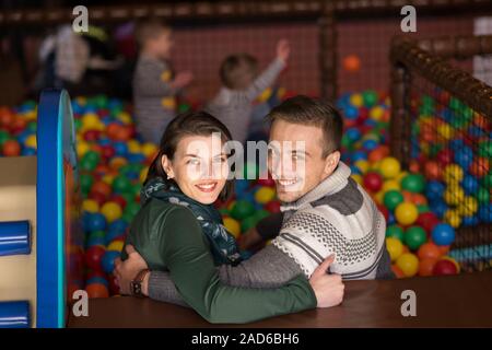 young parents with kids in a children's playroom Stock Photo