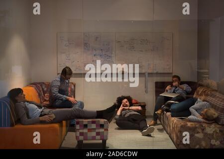 software developers sleeping on sofa in creative startup office Stock Photo