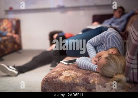 software developers sleeping on sofa in creative startup office Stock Photo