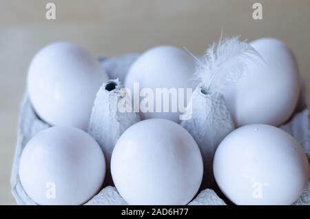 White organic eggs in cartonbox on a table Stock Photo