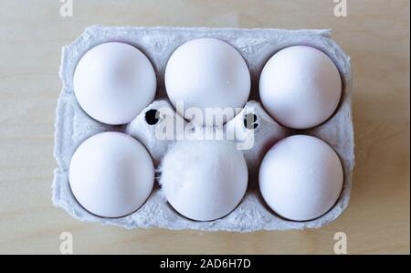White organic eggs in cartonbox on a table Stock Photo
