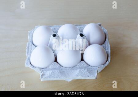 White organic eggs in cartonbox on a table Stock Photo