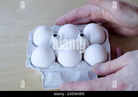 White organic eggs in cartonbox on a table Stock Photo