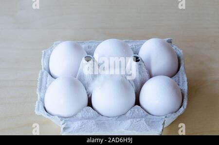 White organic eggs in cartonbox on a table Stock Photo
