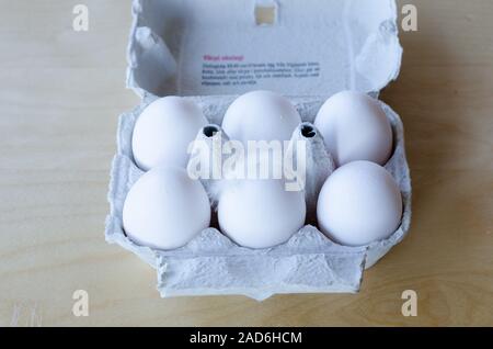 White organic eggs in cartonbox on a table Stock Photo