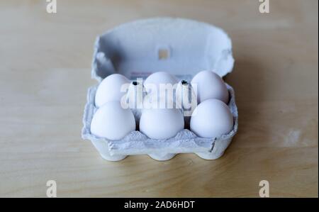 White organic eggs in cartonbox on a table Stock Photo