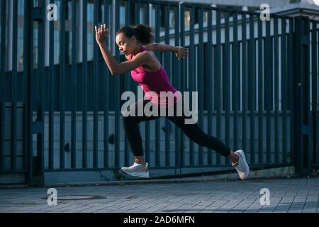 Fit woman running in the street stock photo Stock Photo