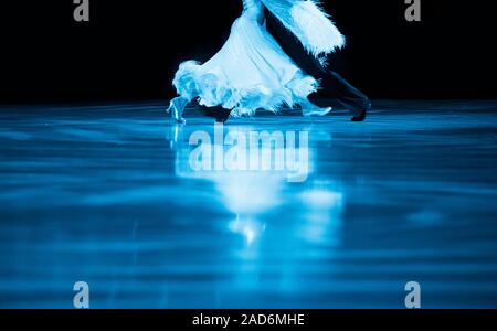 Woman and man dancer latino international dancing. Blue filter Stock Photo