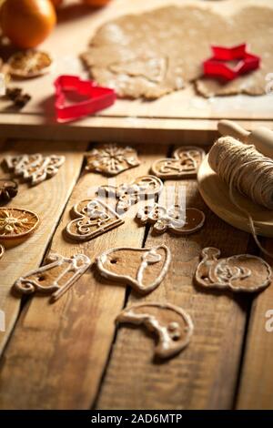 Dough for Christmas gingerbread and cookie cutters on wooden table Stock Photo