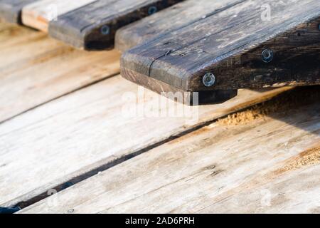 Wooden rafting boats on a pile on the river bank Stock Photo