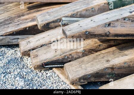 Wooden rafting boats on a pile on the river bank Stock Photo