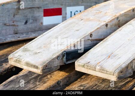 Wooden rafting boats on a pile on the river bank Stock Photo