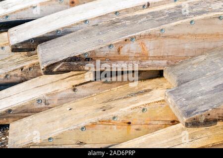 Wooden rafting boats on a pile on the river bank Stock Photo