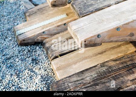 Wooden rafting boats on a pile on the river bank Stock Photo