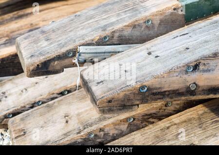 Wooden rafting boats on a pile on the river bank Stock Photo