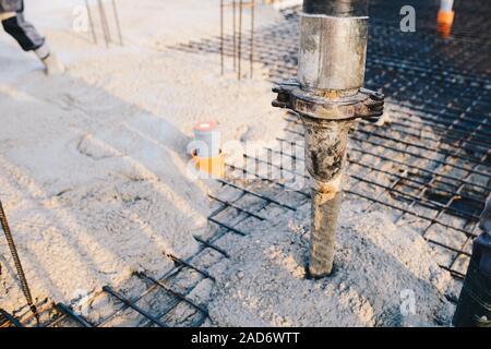 Concrete pouring during commercial concreting floors of buildings in construction Stock Photo