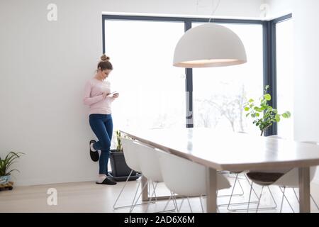 young woman using tablet computer on the floor Stock Photo