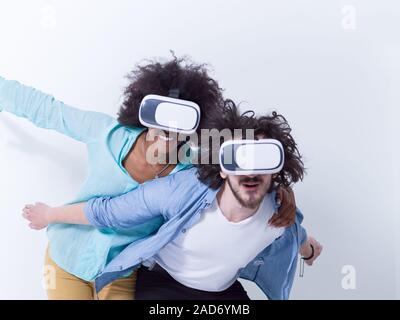 multiethnic couple getting experience using VR headset glasses Stock Photo