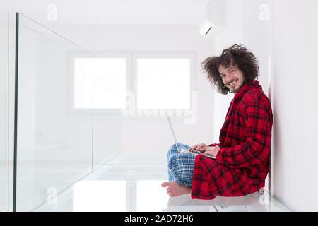young freelancer in bathrobe working from home Stock Photo