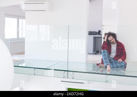 young freelancer in bathrobe working from home Stock Photo