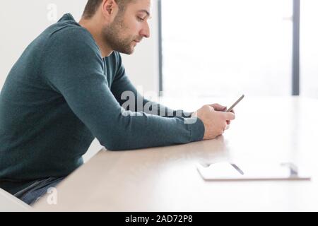 Young casual Businessman using smartphone Stock Photo