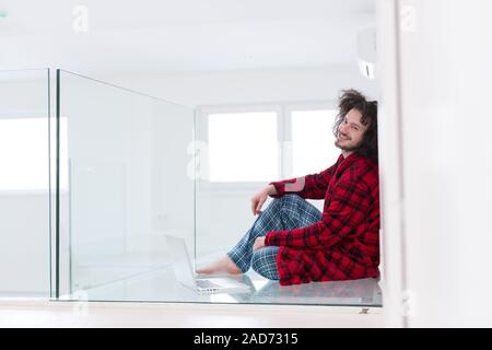 young freelancer in bathrobe working from home Stock Photo