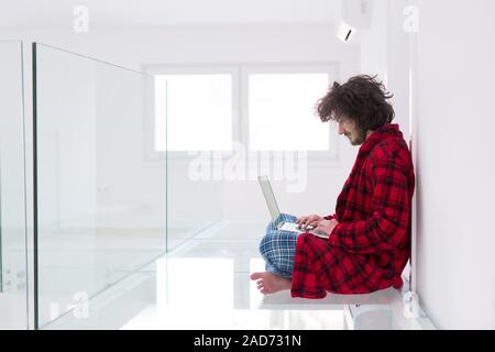 young freelancer in bathrobe working from home Stock Photo