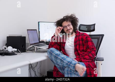 graphic designer in bathrobe working at home Stock Photo