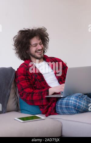 man freelancer in bathrobe working from home Stock Photo