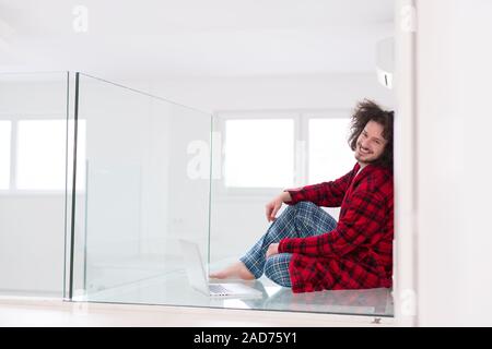 young freelancer in bathrobe working from home Stock Photo
