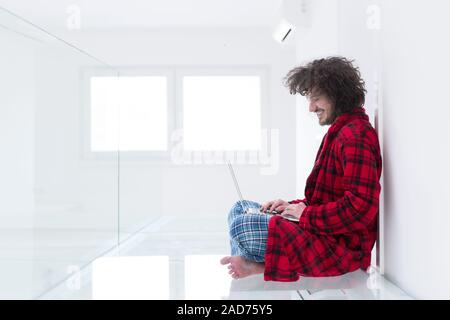 young freelancer in bathrobe working from home Stock Photo